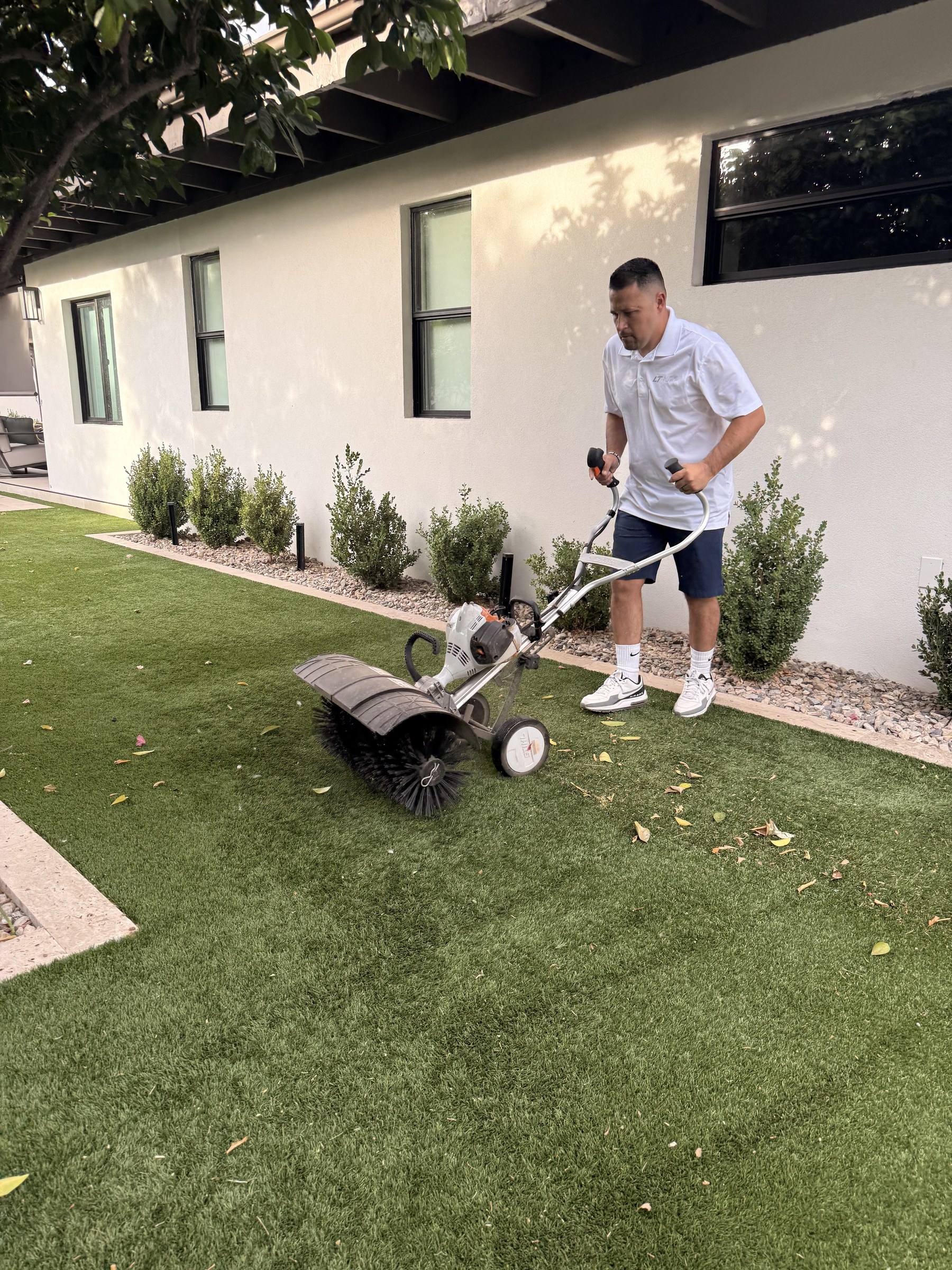 Life Turf crew power broom cleaning artificial turf in Gilbert, AZ