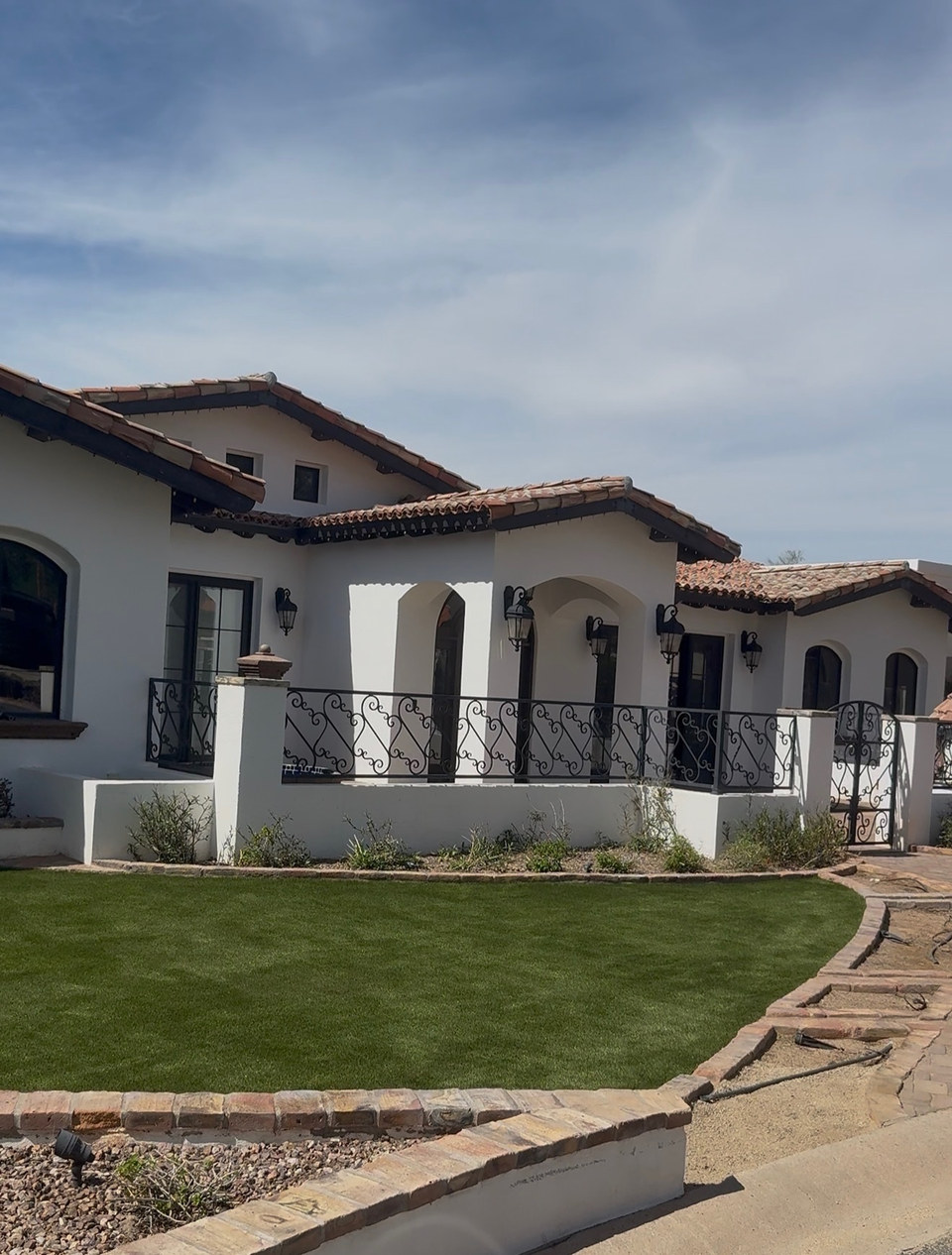 Artificial turf front yard with paver border on a Spanish style home installed by Life Turf