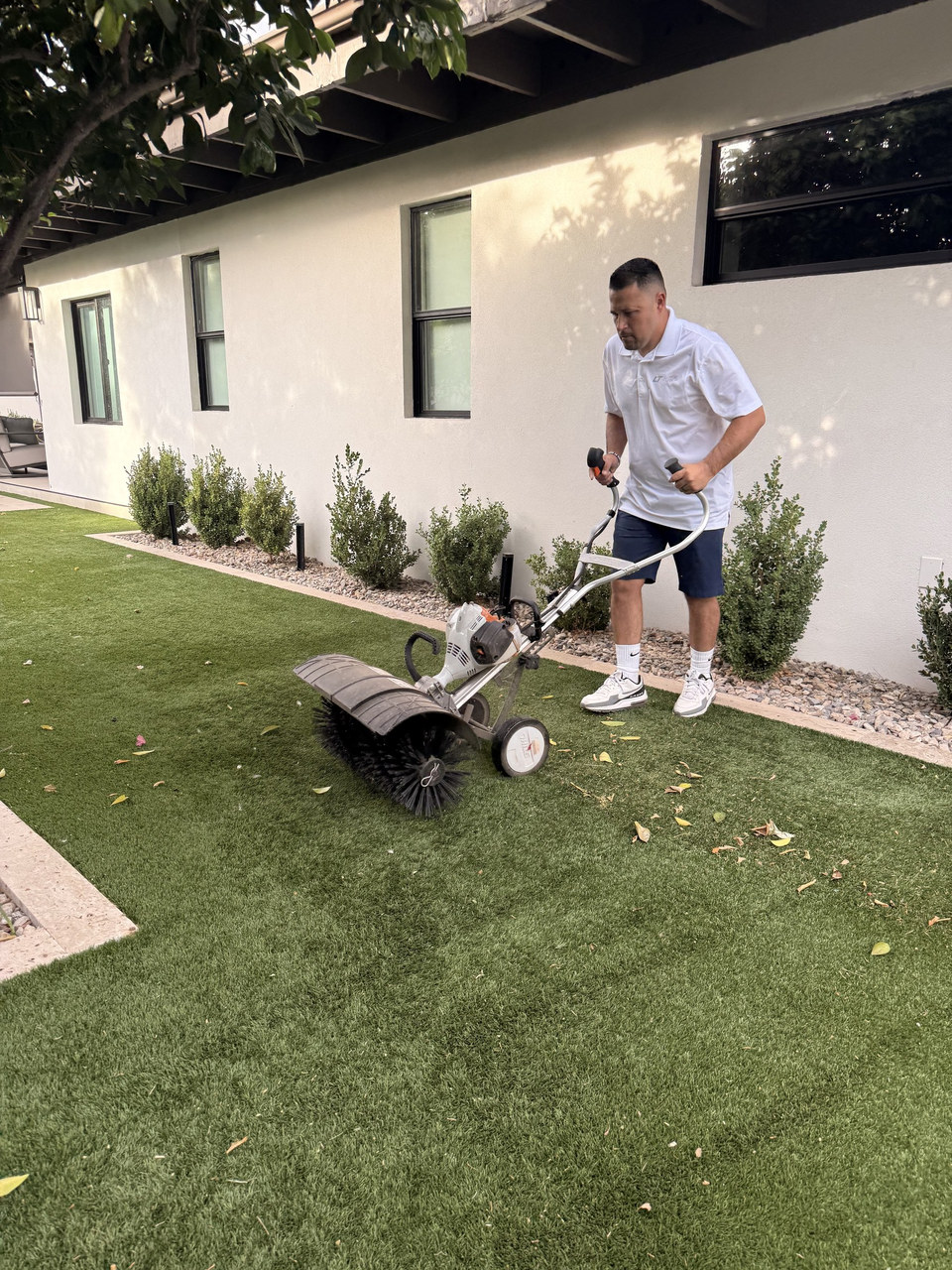 Life Turf crew power broom cleaning artificial turf in Gilbert, AZ