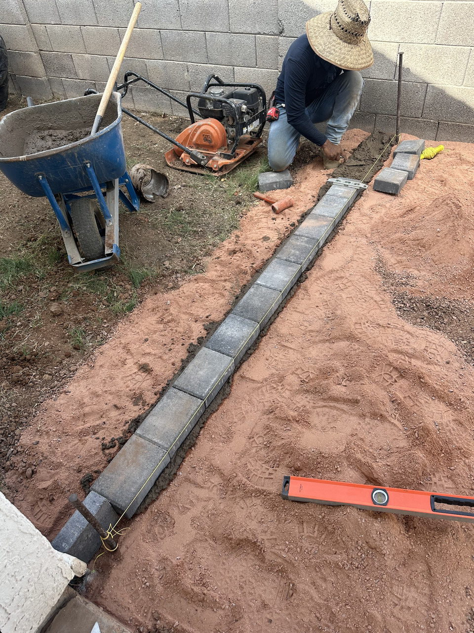 Life Turf crew setting a paver border and compacting base for artificial turf in Arizona